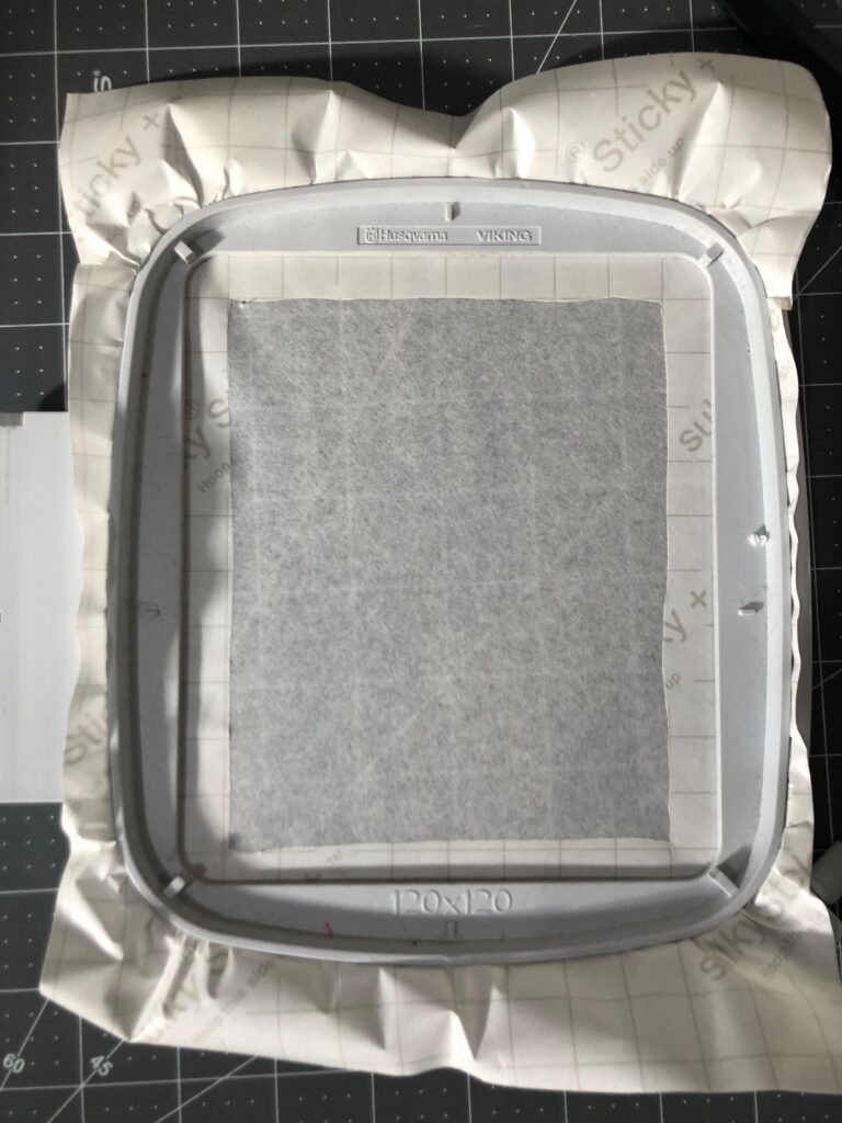 sticky backing showing in hoop